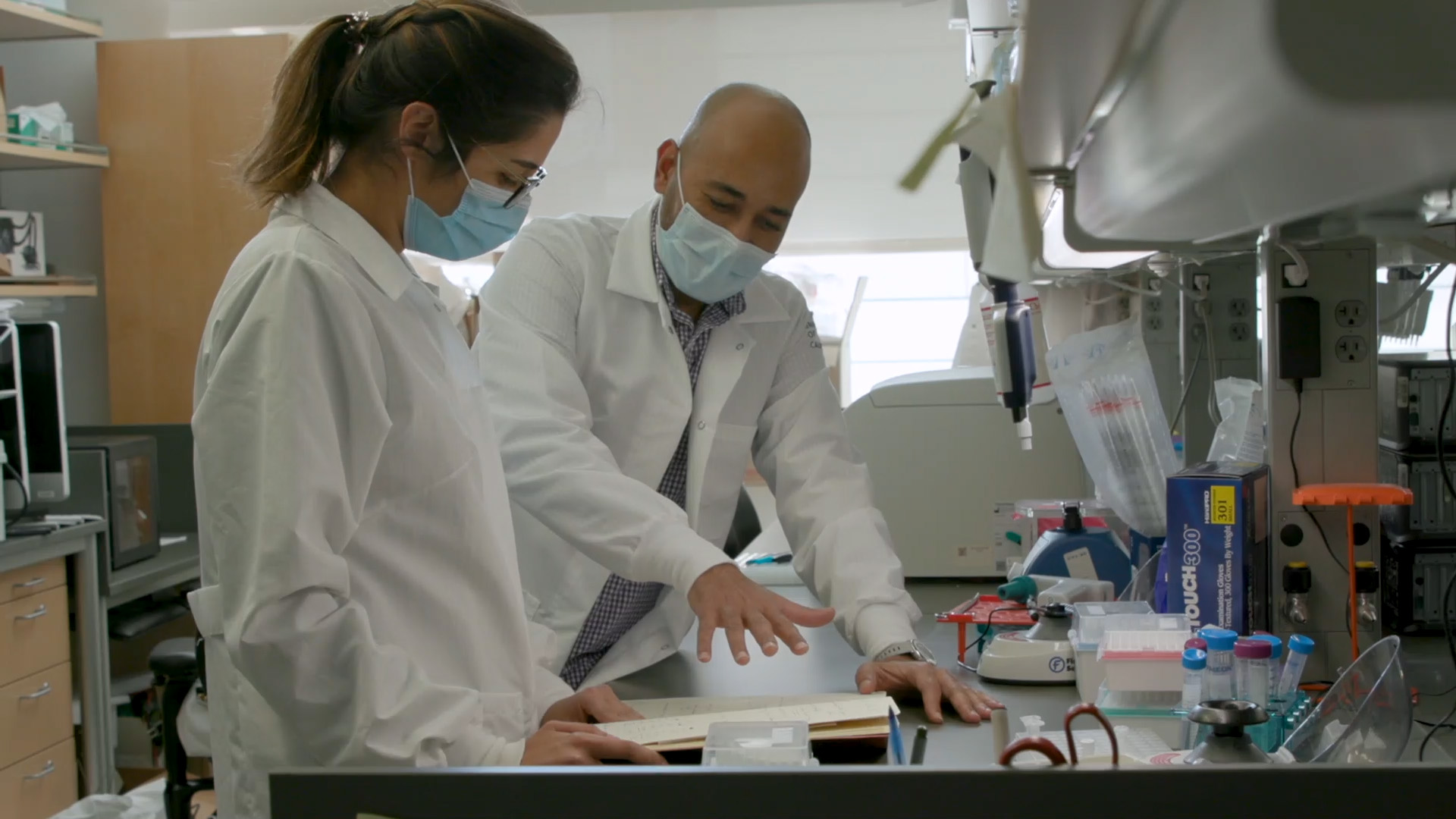 Two people stand together at a lab bench